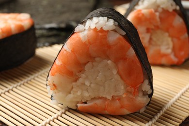 Photo of Tasty onigiri (Japanese rice balls) with shrimps on table, closeup