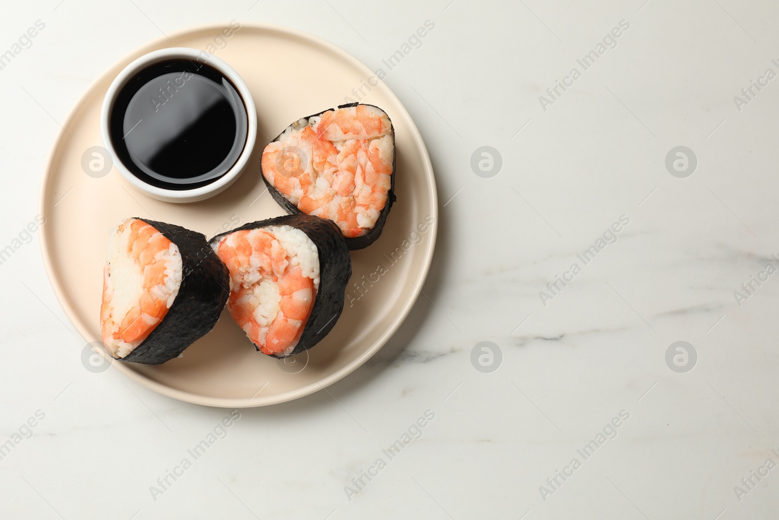 Tasty onigiri (Japanese rice balls) with shrimps and soy sauce on white marble table, top view. Space for text Photo of Tasty onigiri (Japanese rice balls) with shrimps and soy sauce on white marble table, top view. Space for text
