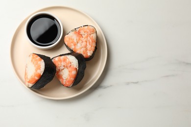 Photo of Tasty onigiri (Japanese rice balls) with shrimps and soy sauce on white marble table, top view. Space for text