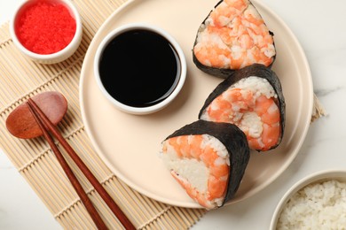 Photo of Tasty onigiri (Japanese rice balls) with shrimps served on white marble table, flat lay