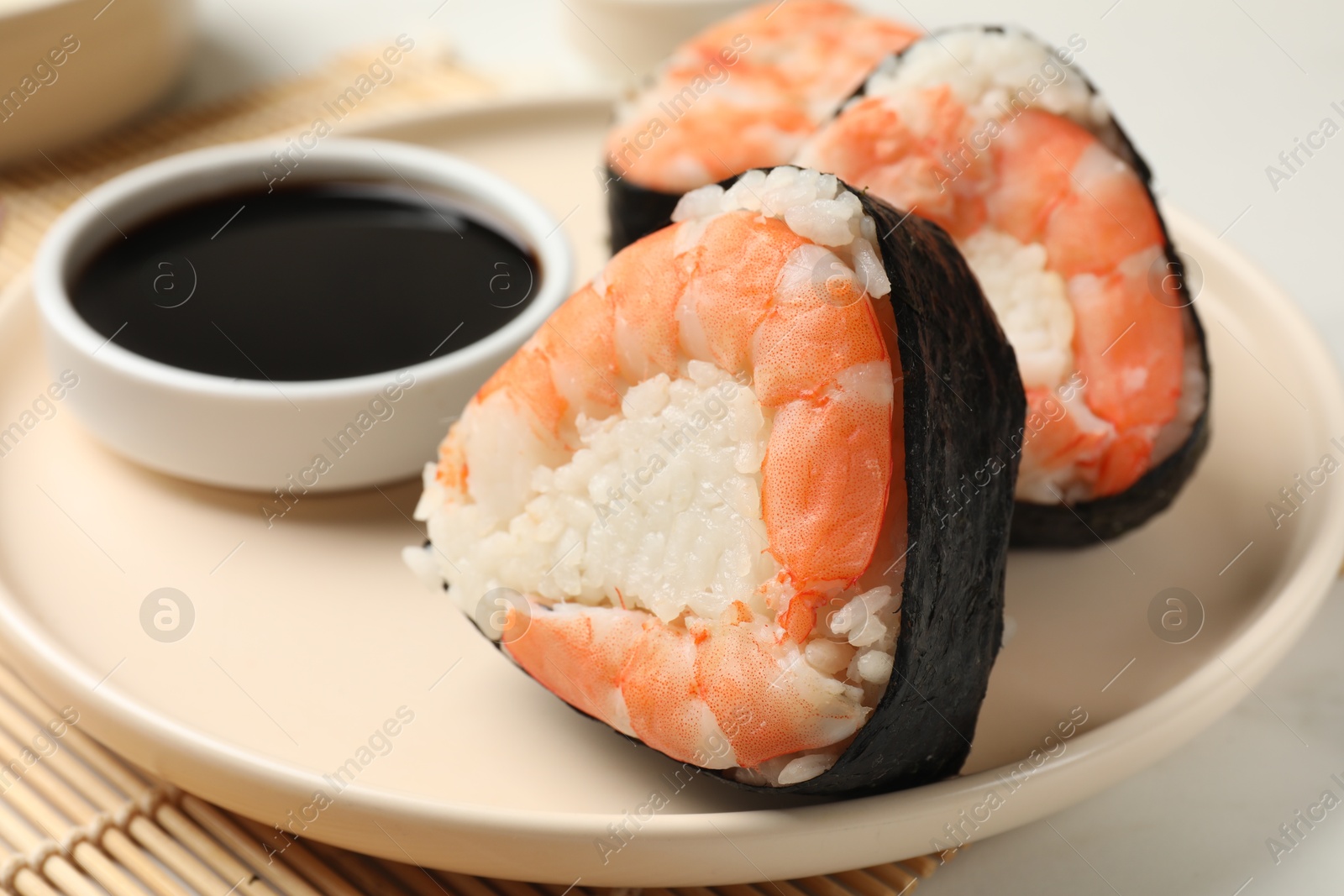 Tasty onigiri (Japanese rice balls) with shrimps and soy sauce on table, closeup Photo of Tasty onigiri (Japanese rice balls) with shrimps and soy sauce on table, closeup