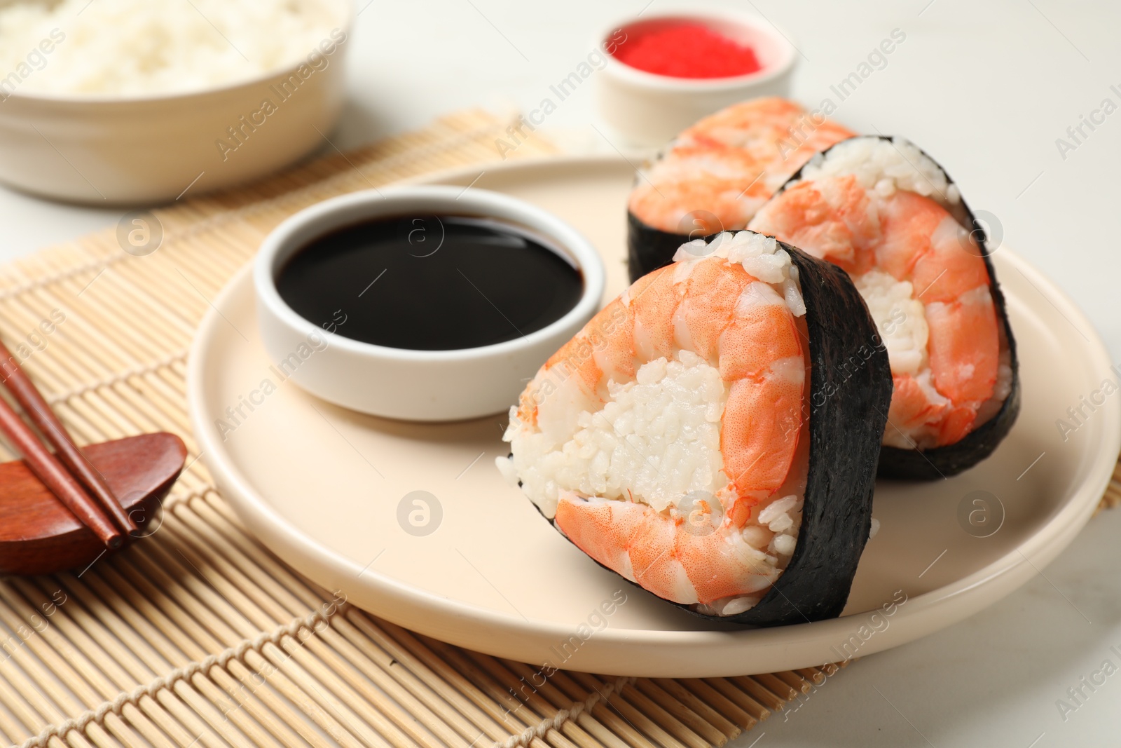 Tasty onigiri (Japanese rice balls) with shrimps served on table, closeup Photo of Tasty onigiri (Japanese rice balls) with shrimps served on table, closeup