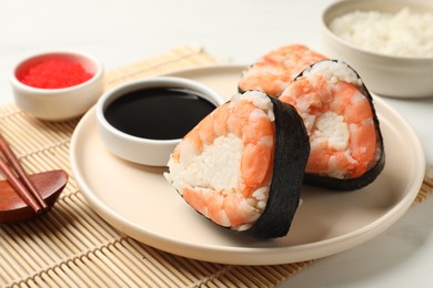 Photo of Tasty onigiri (Japanese rice balls) with shrimps served on table, closeup