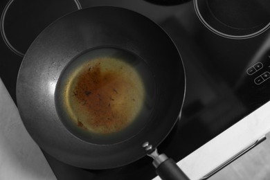 Photo of Used cooking oil in frying pan on stove, above view