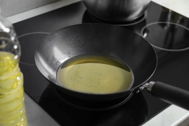 Photo of Used cooking oil in frying pan on stove in kitchen