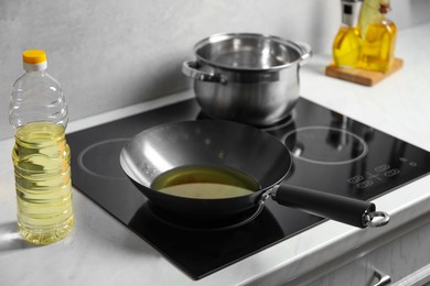 Photo of Frying pan with cooking oil in kitchen