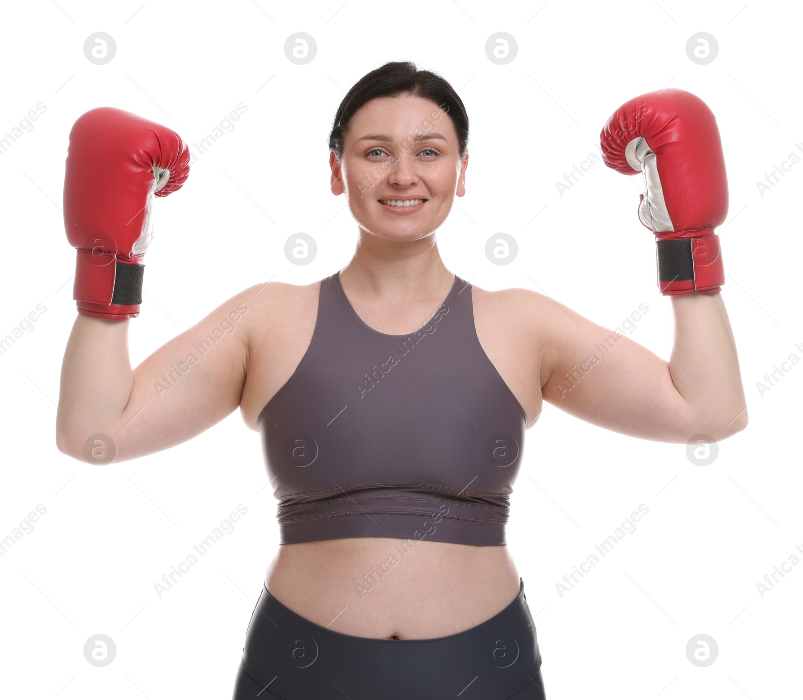 Photo of Plus size woman in gym clothes and boxing gloves on white background