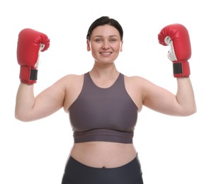 Plus size woman in gym clothes and boxing gloves on white background