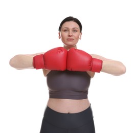 Photo of Plus size woman in gym clothes and boxing gloves on white background