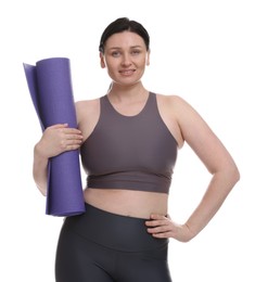 Photo of Plus size woman in gym clothes with fitness mat on white background