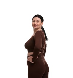 Plus size woman in gym clothes on white background