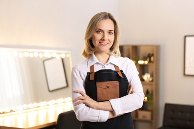 Portrait of smiling hairdresser in beauty salon