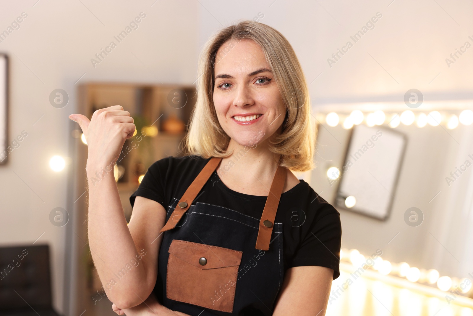 Photo of Portrait of smiling hairdresser in beauty salon