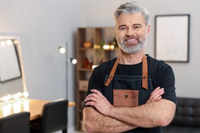 Photo of Portrait of smiling hairdresser in beauty salon, space for text