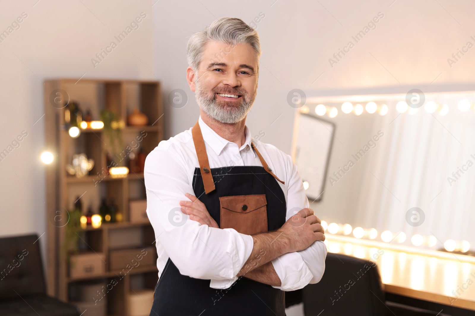 Photo of Portrait of smiling hairdresser in beauty salon