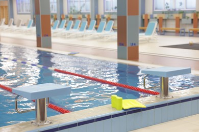 Photo of Swimming pool with clean water and lane dividers indoors