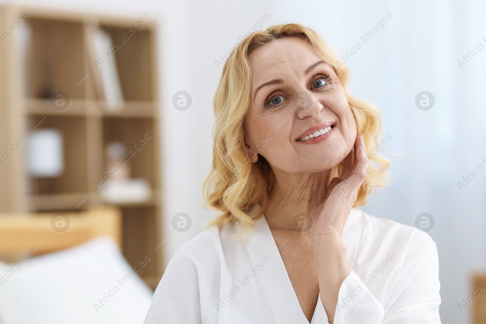 Photo of Portrait of smiling middle aged woman at home. Space for text