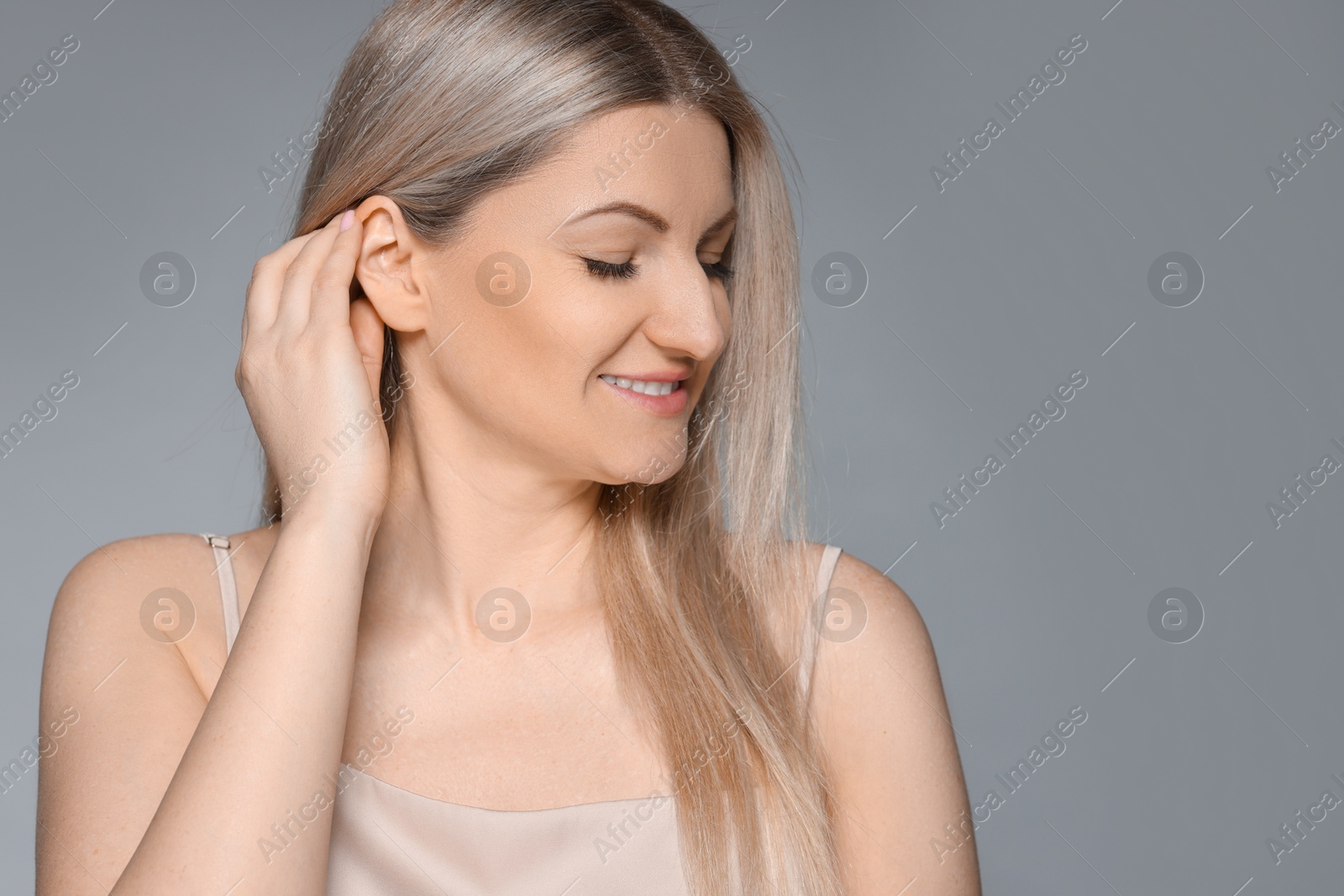 Photo of Portrait of beautiful woman on grey background