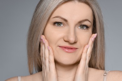 Photo of Portrait of beautiful woman on grey background