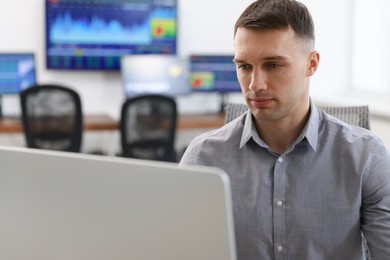 Financial trading specialist working on computer in office