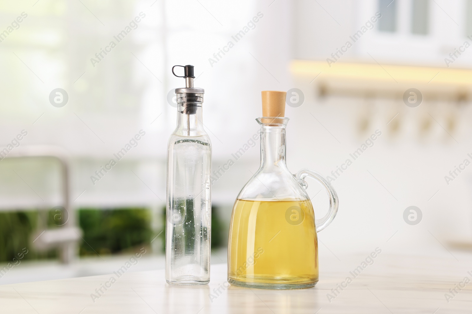 Photo of Salad dressings in bottles on table indoors