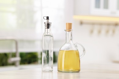 Photo of Salad dressings in bottles on table indoors