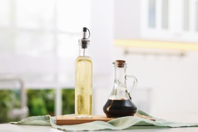 Photo of Salad dressings in bottles on table indoors