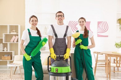 Cleaning service workers with equipment in room