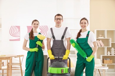 Photo of Cleaning service workers with equipment in room