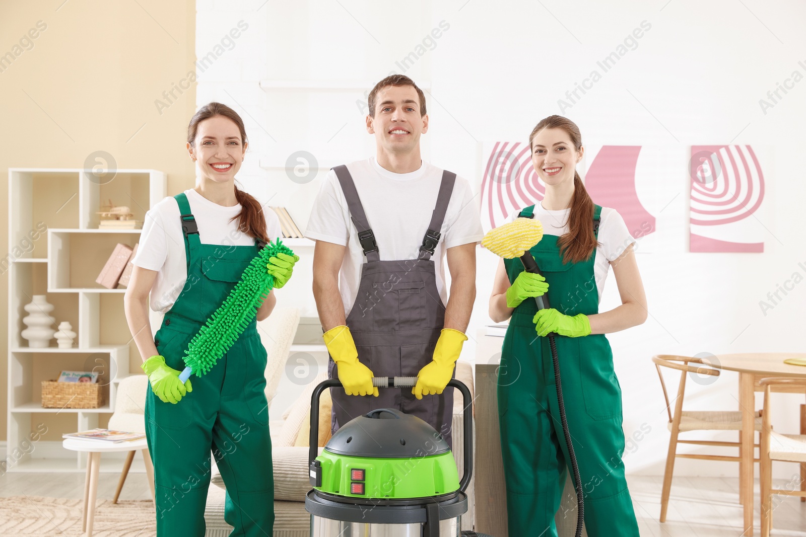 Photo of Cleaning service workers with equipment in room