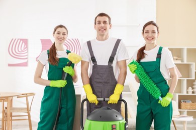 Cleaning service workers with equipment in room