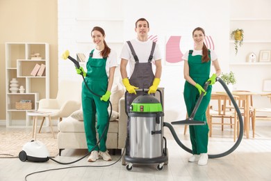 Cleaning service workers with equipment in room