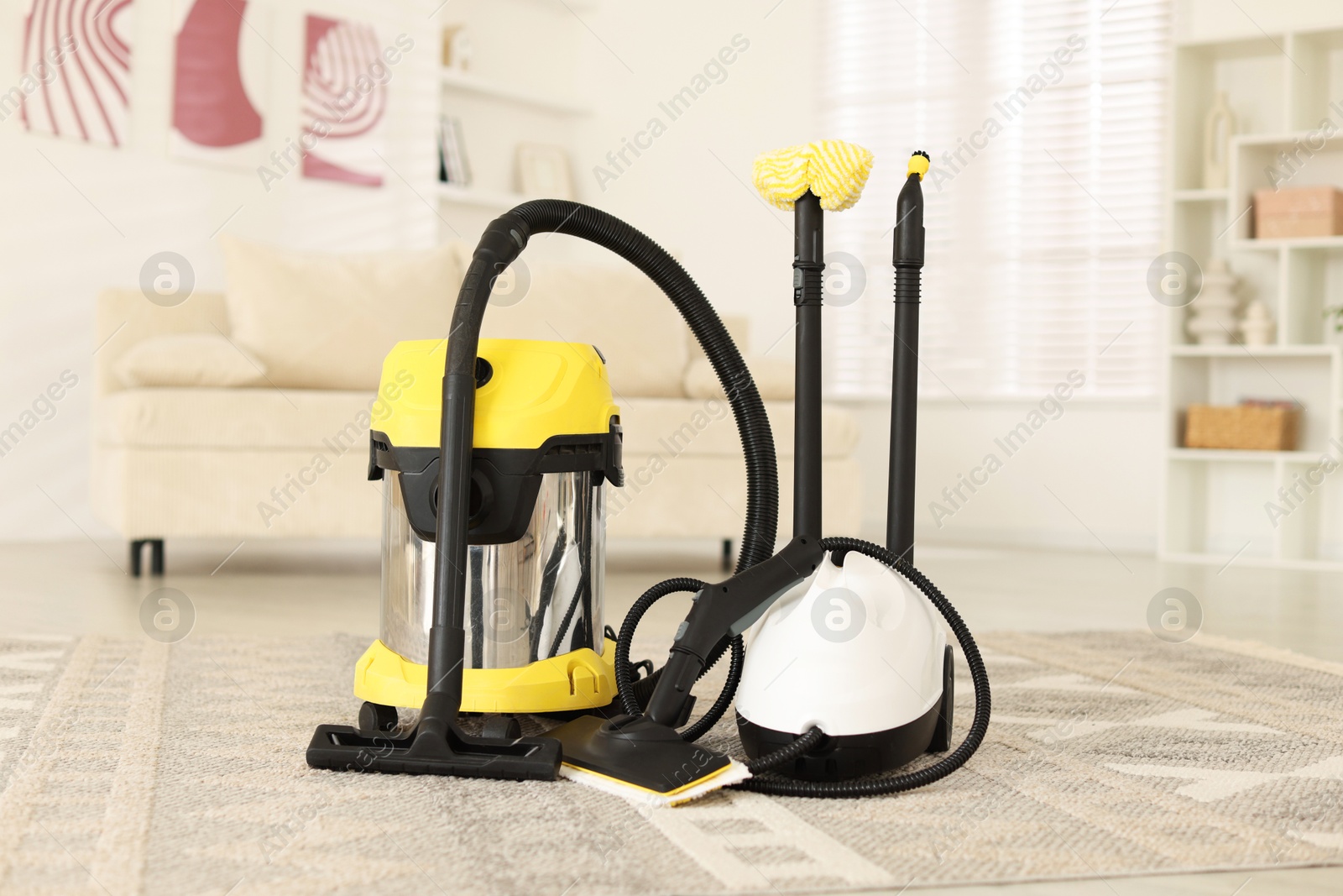 Photo of Professional hoover and vapor steam system at home. Cleaning appliances