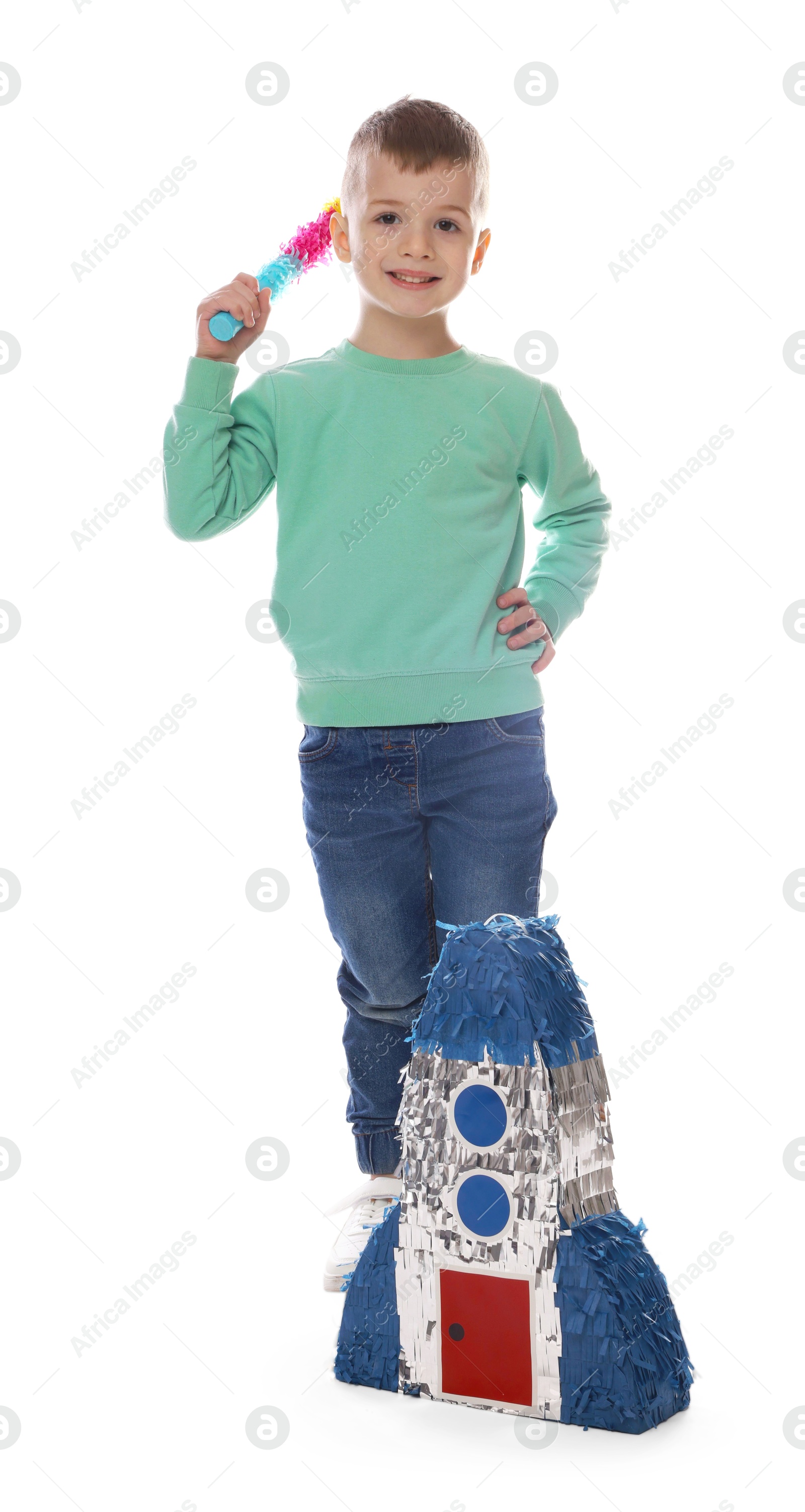 Photo of Happy boy with rocket shaped pinata and stick on white background