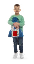 Happy boy with rocket shaped pinata on white background