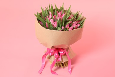 Bouquet of beautiful tulips on pink background