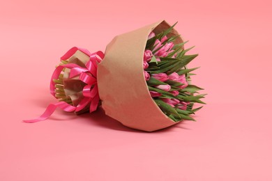 Bouquet of beautiful tulips on pink background