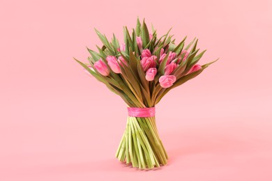 Photo of Bouquet of beautiful tulips on pink background