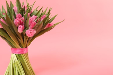 Photo of Bouquet of beautiful tulips on pink background, closeup. Space for text