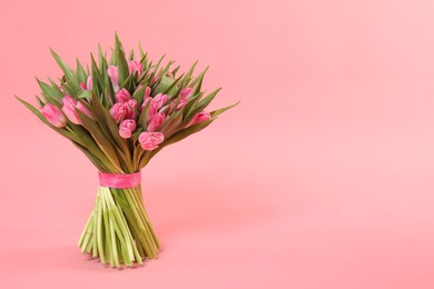 Bouquet of beautiful tulips on pink background, space for text