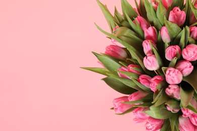 Bouquet of beautiful tulips on pink background, top view. Space for text