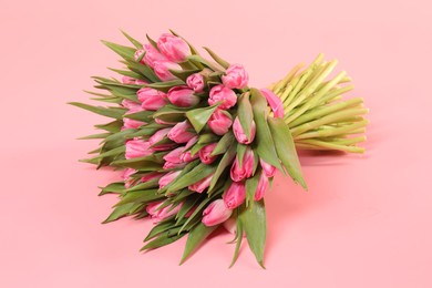 Bouquet of beautiful tulips on pink background