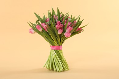 Bouquet of beautiful tulips on beige background