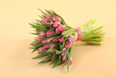 Bouquet of beautiful tulips on beige background