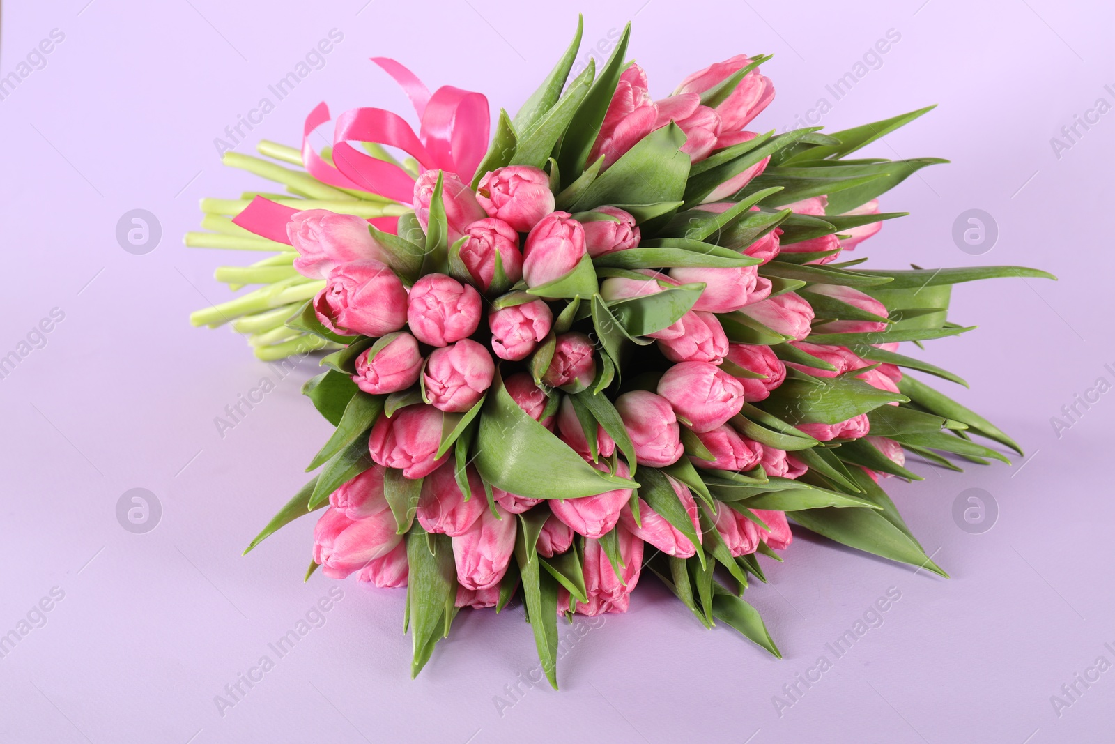 Photo of Bouquet of beautiful tulips on lilac background