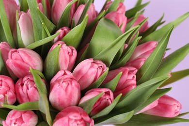 Photo of Bouquet of beautiful tulips on lilac background, closeup