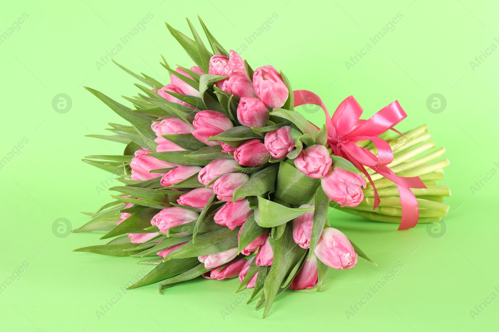 Photo of Bouquet of beautiful tulips on green background