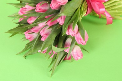 Photo of Bouquet of beautiful tulips on green background, closeup. Space for text