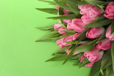 Photo of Bouquet of beautiful tulips on green background, closeup. Space for text