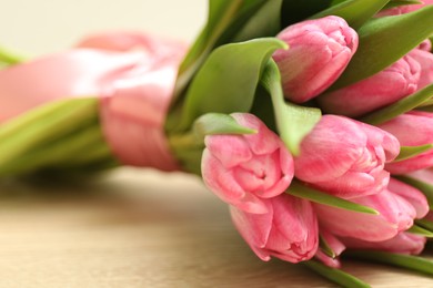 Photo of Bouquet of beautiful tulips on table, closeup. Space for text